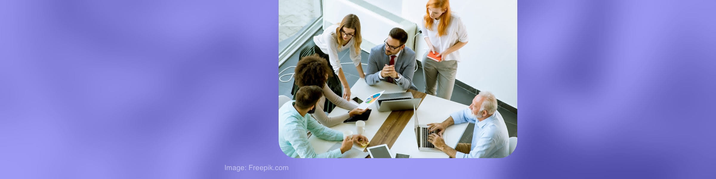 Hiring team reviewing candidate information around a table